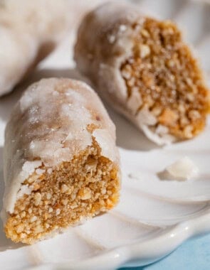 A close up of two alfajores halves on a plate.