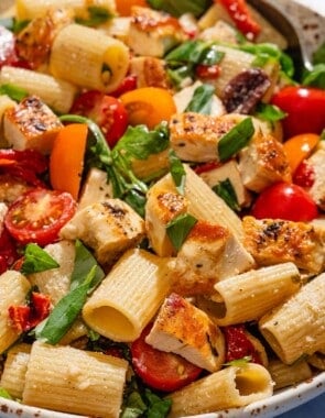 Chicken pasta salad in a serving bowl with a spoon.