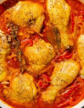 Chicken and peppers in a skillet.