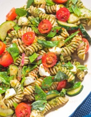Pesto pasta salad on a platter.
