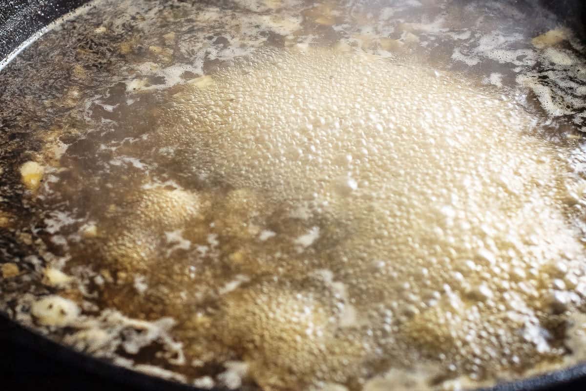 the pan sauce aggressively bubbling in the cast iron skillet for the cilantro lime chicken recipe.