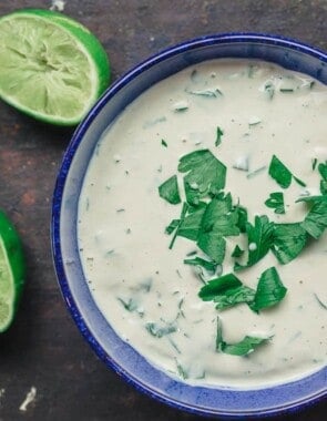 Tahini sauce with parsley. Lime juice to the side