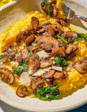 A plate of mushroom polenta with a fork.