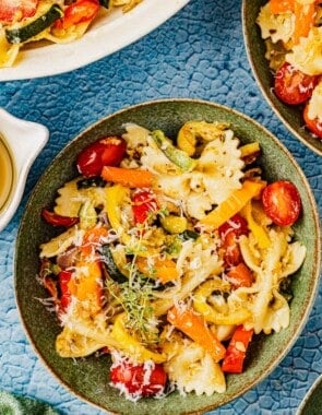 overhead photo of pasta primavera in a green bowl.